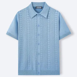 Close up detail of mens light blue knit polo shirt showing textured pattern and buttons.