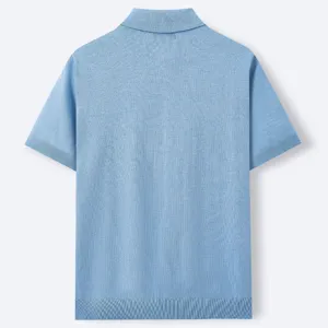 Detailed back view of light blue knitted polo shirt, highlighting fine texture and ribbed cuffs.