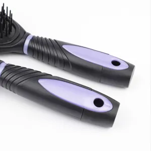 Detail view of the ergonomic black and purple hair brush handles featuring convenient hanging holes.