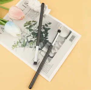 Detail view of soft eyeshadow blending makeup brush with slim handle for eye makeup.