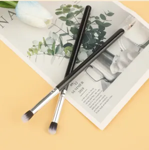 Black handle makeup brush detail showing soft bristles for precise eyeshadow blending.