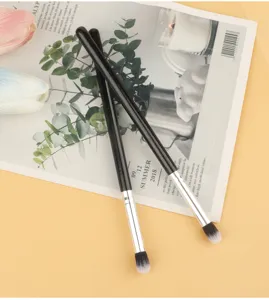 Soft eyeshadow blending brush detail, professional makeup tool for precise eye shadow application.