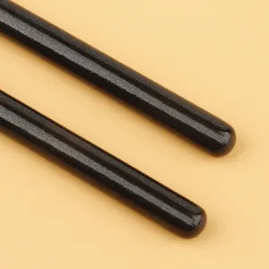 Professional makeup brush detail view, black sparkly eyeshadow blending brush for precise application