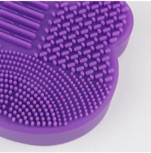 Silicone makeup brush cleaning mat detail view in purple with textured scrubbing surfaces.