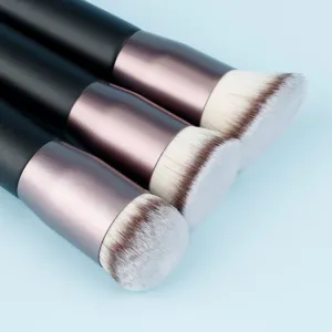 Foundation brush detail, dense soft synthetic bristles, sleek black handle for smooth makeup.