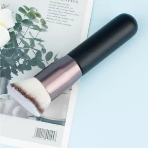 Detail shot of portable makeup foundation brush with soft dense bristles and black handle.