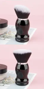 Large round makeup brush with black handle and soft white bristles for powder and nail dust.
