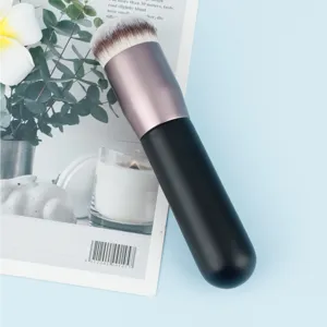 Portable flat top foundation makeup brush for flawless liquid cosmetic application detail.