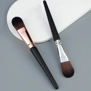 Detail view of professional cosmetic brushes with soft bristles and black handles.