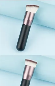 Close-up detail of dense angled foundation makeup brush with soft bristles and sleek handle.