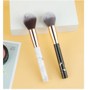 Marble handle makeup brush featuring soft dense bristles and golden ferrule for smooth application.