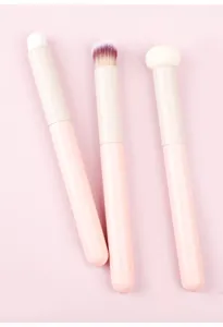 Pink makeup brush set detail, soft bristles and sponge heads for smooth concealer application.