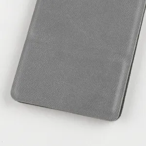 Detail view of the grey textured leather protective cover for the portable folding mirror.