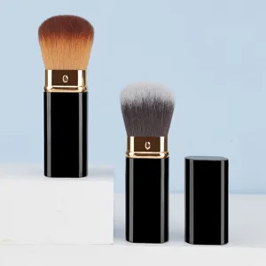 Detail view of portable square retractable makeup brush with soft bristles and protective cap.
