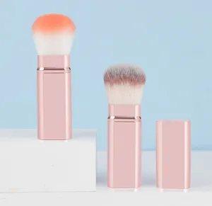 Detail view of the portable retractable makeup brush with rose gold square case and soft bristles.