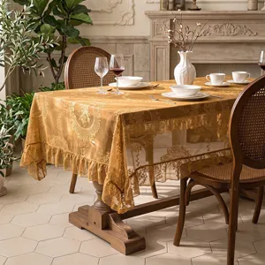 Elegant golden lace tablecloth with vintage floral embroidery and ruffled edge for dining.