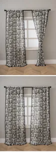 Linen style curtain detail featuring vintage floral print and chic black fringe tassels setup.