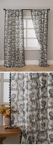 Detailed view of linen curtain with black tassel trim, showcasing fabric texture and scene.