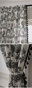 Linen blend curtain detail shot, marine seahorse shell print, elegant black tassel trim.