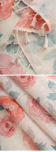 Detailaufnahme von Leinenstoff Vorhang mit Blumenmuster und Quasten Verzierung.