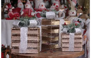 Detail view of Christmas iron art gift box decorations, set of three holiday display ornaments.