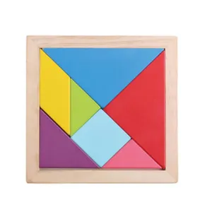 Wooden tangram puzzle detail showing colorful geometric shapes inside a square wooden frame tray.