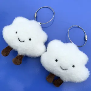 Cute cloud plush keychain detail shot, fluffy white toy with brown legs and metal ring.
