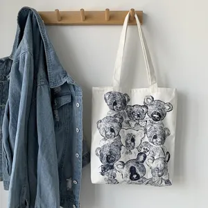 Detailed view of white canvas tote bag featuring vintage teddy bear sketch art print.