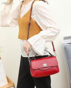 Red genuine leather crossbody handbag with top handle and metal lock for women stylish daily use.