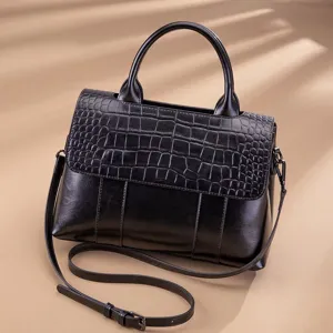 Black leather women top handle shoulder bag with chic crocodile embossed flap design.