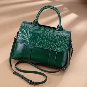 Green leather retro shoulder bag with crocodile embossed flap and top handle design.