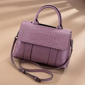 Close-up detail of the vintage purple leather handbag showcasing its exquisite crocodile texture.