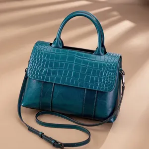 Detail view of vintage genuine leather women handbag, crocodile texture flap, stylish shoulder bag.