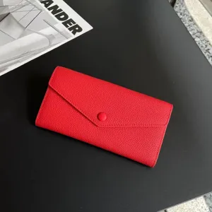 Red genuine leather long wallet, classic envelope design with snap button and pebble grain texture.