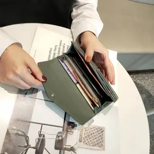 Detailed view of the dark green leather long wallet interior, showcasing card slots and zipper pocket.