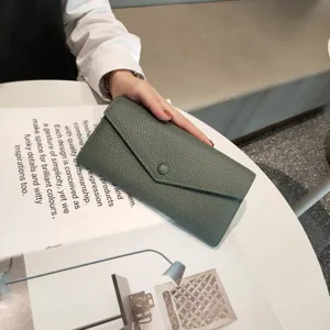 Close-up of genuine leather long wallet in elegant olive green with textured pebble finish.