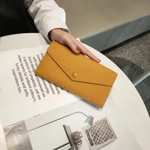 Genuine leather long envelope wallet detail view showing soft pebbled texture and snap button.