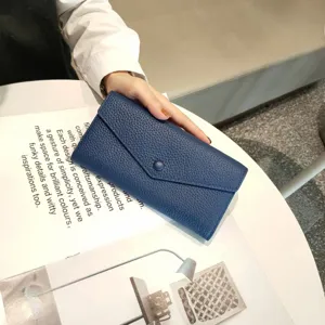 Blue leather long wallet detail, soft cowhide material, elegant envelope design with snap button.