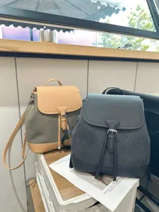 Vue détaillée d'un sac à dos décontracté en toile avec bordure en cuir pour voyage.