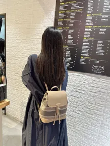 Sac à dos casual en toile et cuir pour femme, design tendance et élégant pour le voyage.