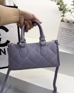 Detail shot of the lavender quilted shoulder bag, showing fine stitching and metal hardware.