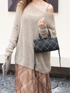 Stylish minimalist shoulder bag for women, chic black leather pillow handbag with white stitching.