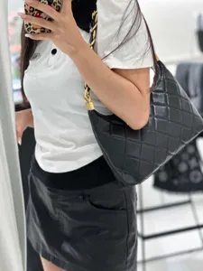 Detail shot of a black quilted shoulder bag with chain strap, perfect for daily wear.
