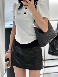 Black quilted leather shoulder bag with chain strap, retro underarm commuter handbag detail.
