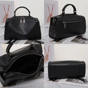 Vista dettagliata della borsa a mano in pelle nera da donna con manico e tasche con zip.