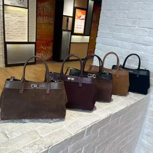 Detailed view of versatile frosted leather tote bags in multiple colors with metal lock closure.