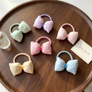 Jolis élastiques à cheveux à nœud papillon à pois style coréen pour femmes et filles.