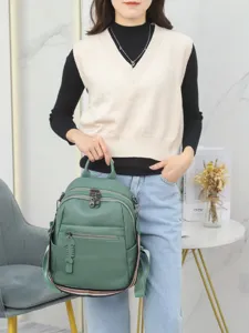 Minimalist leather backpack for women, stylish green casual daypack with spacious compartments.