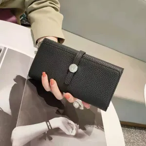Black leather long wallet with pebbled texture, stylish vertical strap and button closure.