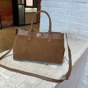 Classic brown suede tote bag with top handle and shoulder strap for women daily wear.